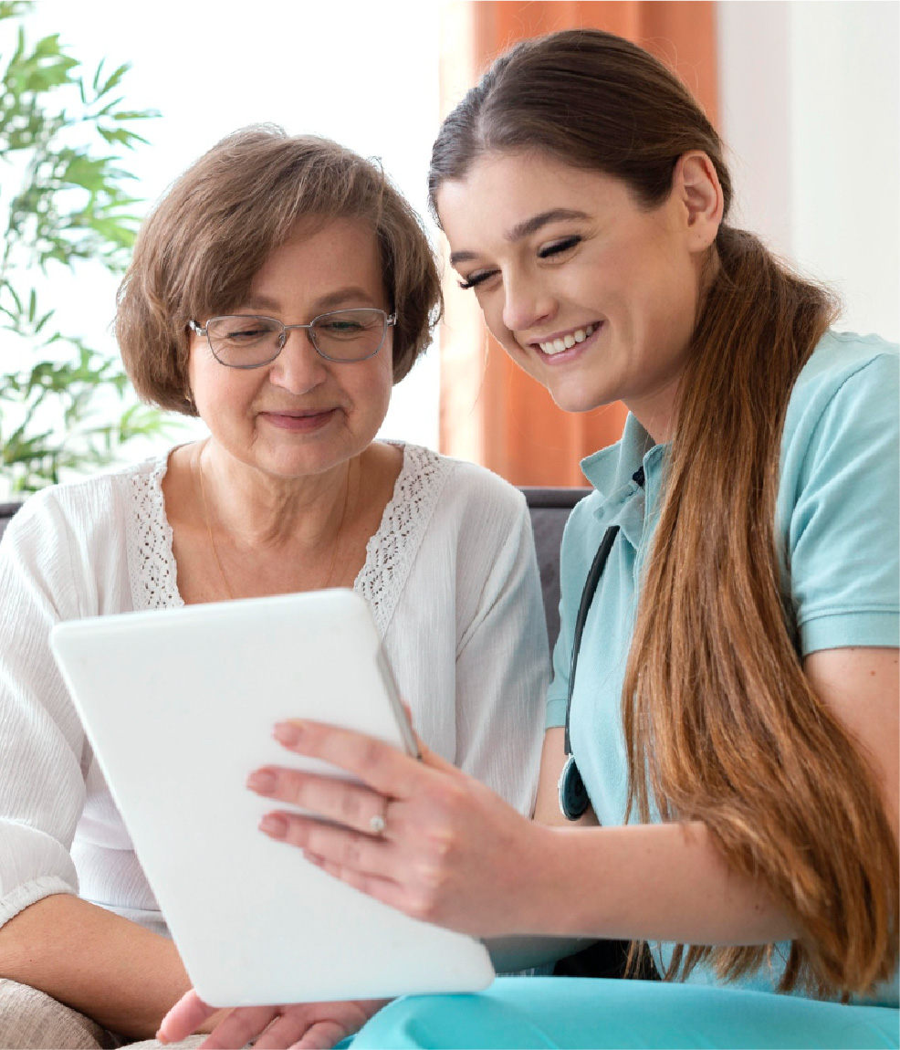 Support coordinator with a participant reviewing a plan on a tablet